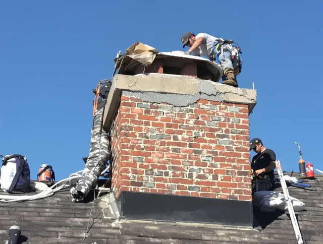 Brook Park Chimney Sweep installing a custom chimney crown in Brook Park, OH